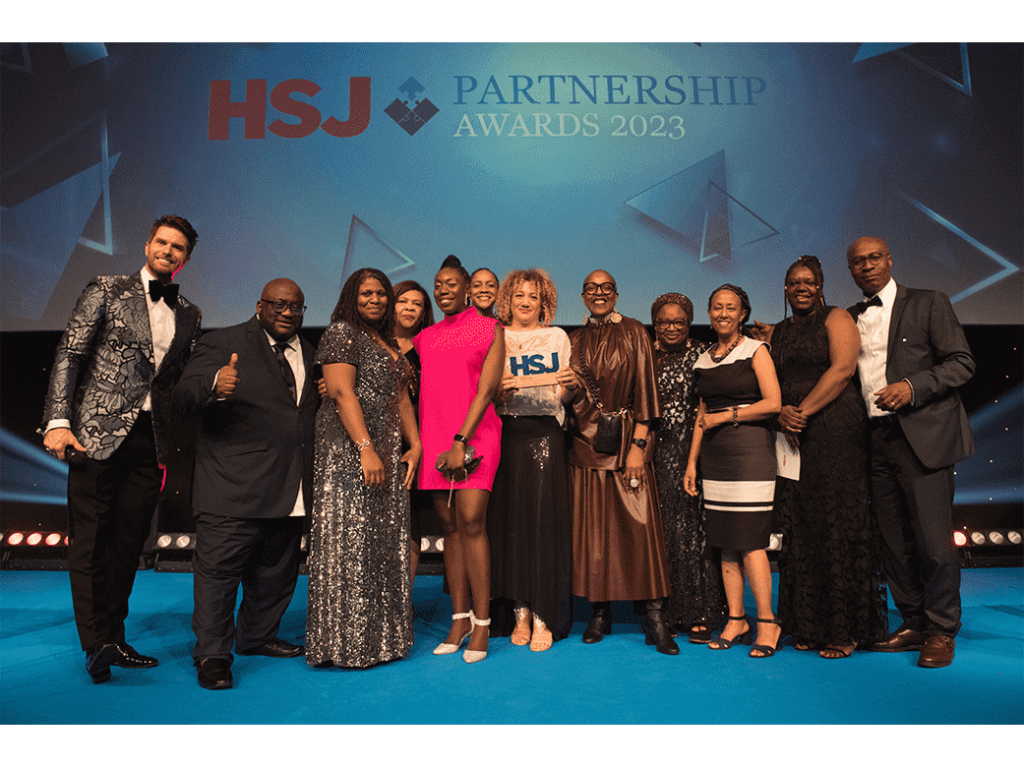 picture of the capsa team dressed in evening wear posing with their award