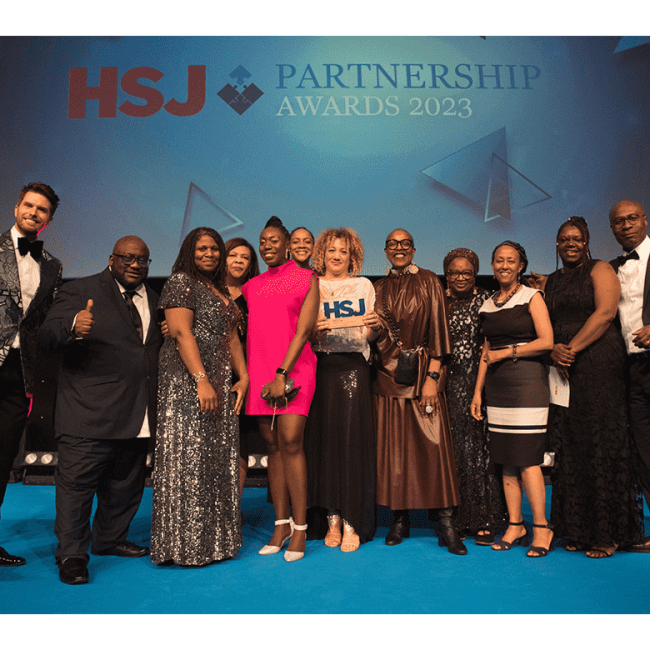 picture of the capsa team dressed in evening wear posing with their award